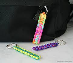 Paracord keychains in rainbow, purple, and green.