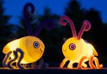 Two lightning bugs made from easter eggs and pipe cleaners.