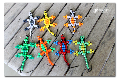 Colorful lizards made from pony beads and string.