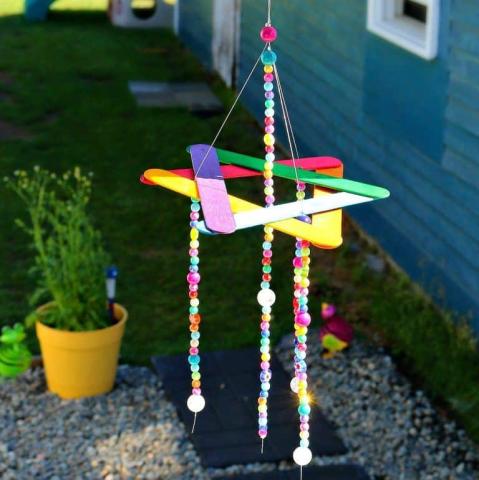 a windchime made from craft sticks and beads.