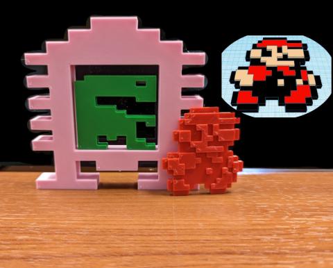 3D printed ET from the ET atari game, and a 3D printed Mario sprite from Super Mario Bros 3.