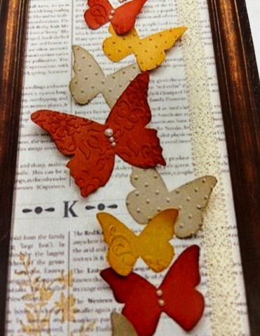 Framed butterfly art piece; created using scrapbook materials.